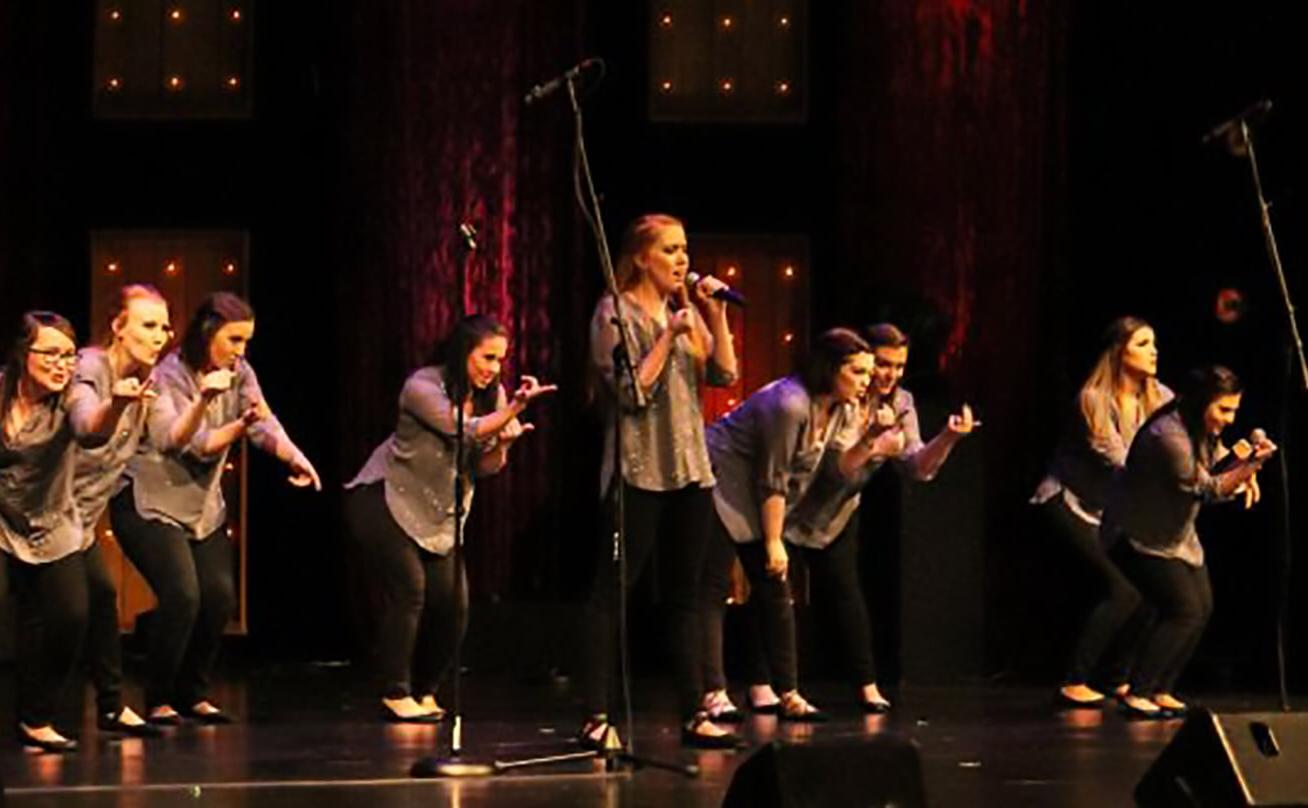 Women's group singing on stage